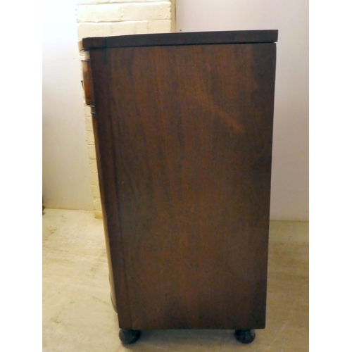 132 - A Regency mahogany bowfront sideboard with a frieze drawer, over two panelled doors, raised on turne... 