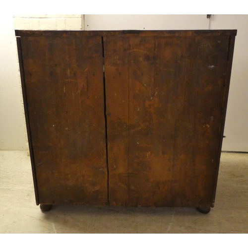 132 - A Regency mahogany bowfront sideboard with a frieze drawer, over two panelled doors, raised on turne... 