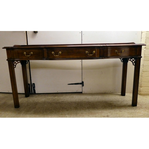 137 - A modern reproduction of a Georgian design, mahogany breakfront, three drawer hall table, raised on ... 