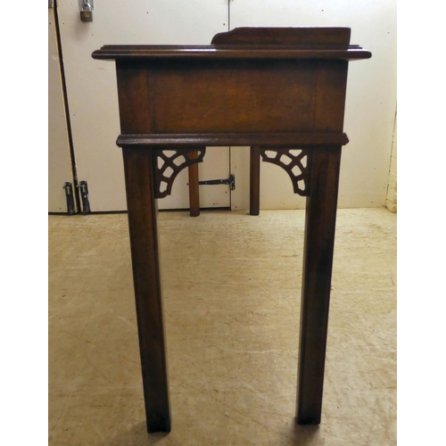 137 - A modern reproduction of a Georgian design, mahogany breakfront, three drawer hall table, raised on ... 