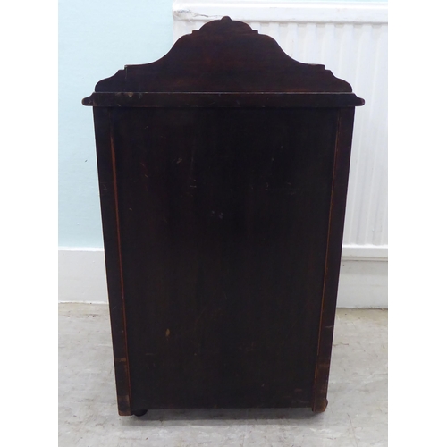 14 - An Edwardian rosewood purdonium with a fall front, on casters  25