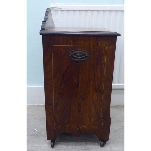 14 - An Edwardian rosewood purdonium with a fall front, on casters  25