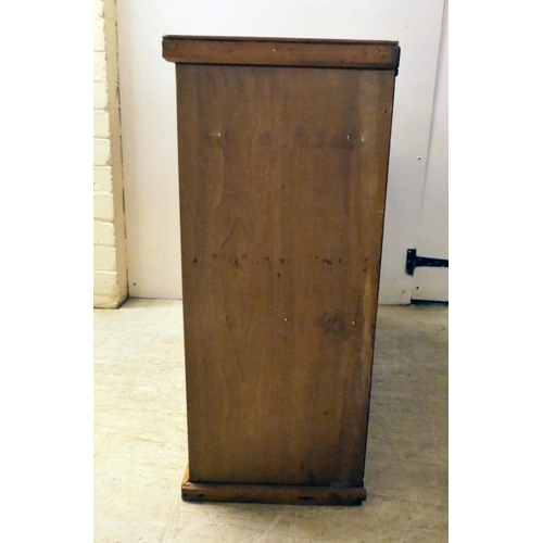 145 - A 20thC pine cabinet with two glazed, sliding doors, on a plinth  27