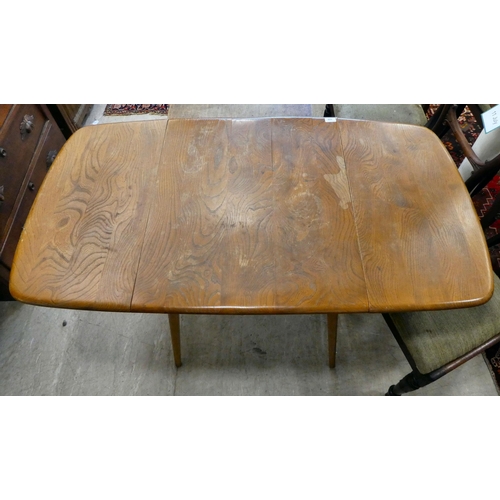 159 - An Ercol elm drop-leaf dining table, raised on tapered legs  28