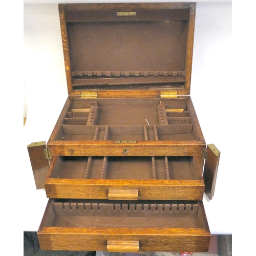 16 - A mid 20thC oak (empty) canteen chest with straight sides and a hinged lid, over two drawers, on a p... 