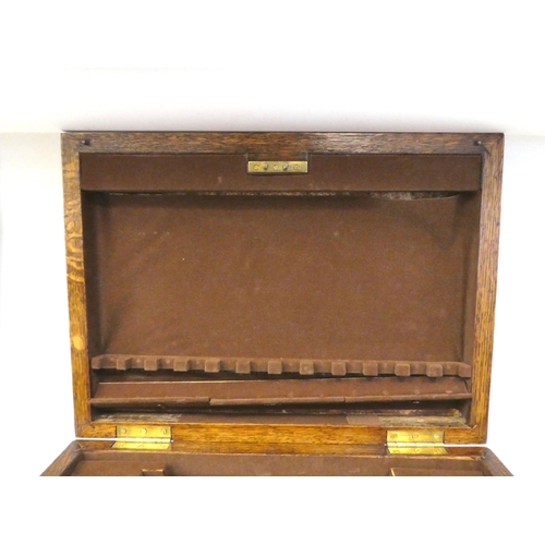 16 - A mid 20thC oak (empty) canteen chest with straight sides and a hinged lid, over two drawers, on a p... 