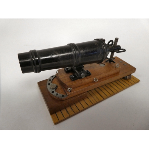 175 - A miniature model cannon with a bronze barrel, on a hardwood carriage  6.5