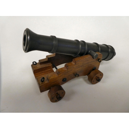 175 - A miniature model cannon with a bronze barrel, on a hardwood carriage  6.5