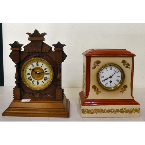 176 - A late 19thC American carved walnut cased mantel clock; the Ansonia movement faced by a two part Rom... 