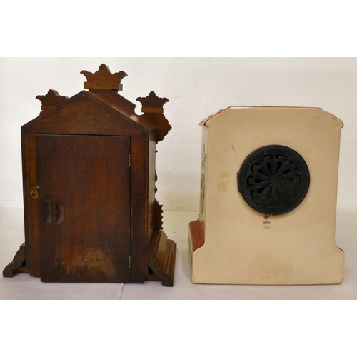 176 - A late 19thC American carved walnut cased mantel clock; the Ansonia movement faced by a two part Rom... 