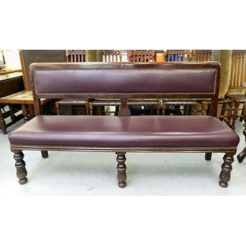 349 - A 20thC mahogany framed and stud upholstered burgundy coloured hide settee, raised on carved foreleg... 