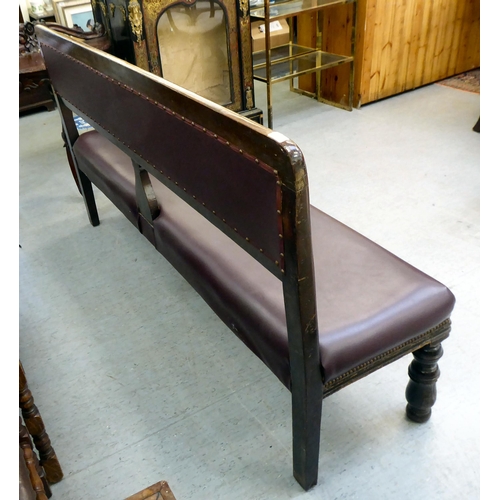 349 - A 20thC mahogany framed and stud upholstered burgundy coloured hide settee, raised on carved foreleg... 