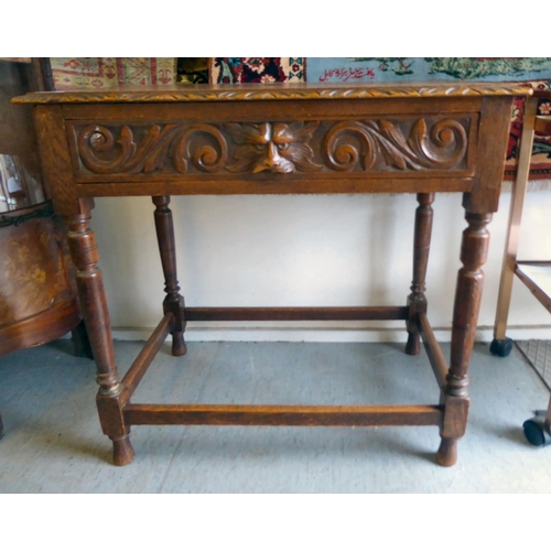 358 - A late Victorian oak hall table with a carved border and lion mask handle to the frieze drawer, rais... 