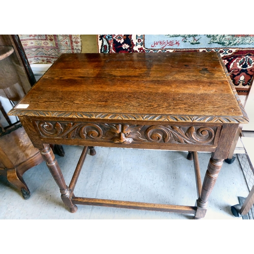 358 - A late Victorian oak hall table with a carved border and lion mask handle to the frieze drawer, rais... 