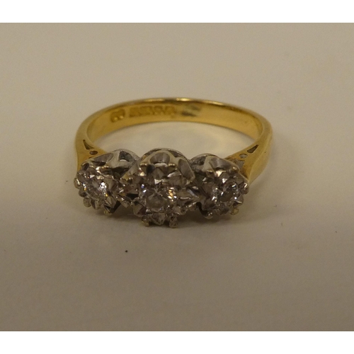 363 - An 18ct gold three stone diamond ring 