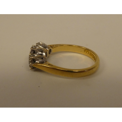 363 - An 18ct gold three stone diamond ring 