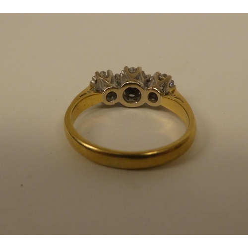 363 - An 18ct gold three stone diamond ring 