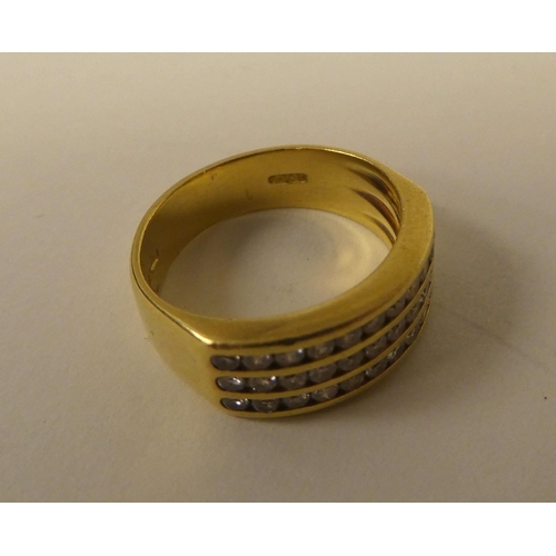 365 - An 18ct gold ring, set with three rows of diamonds 