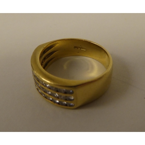 365 - An 18ct gold ring, set with three rows of diamonds 