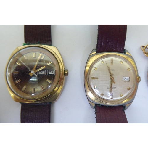 377 - A mixed lot: to include a 1980s Timex gold plated wristwatch, faced by a baton dial, on a brown leat... 