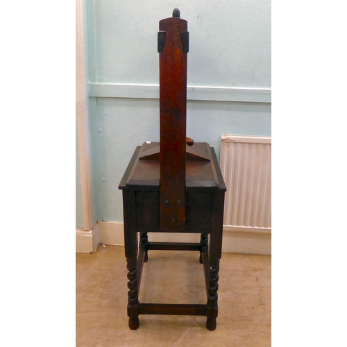 38 - An early 20thC bookpress with a deep drawer and a compatible superstructure, incorporating a central... 