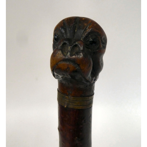 39 - A late 19thC treen page turner with a boxer dog's head carved finial