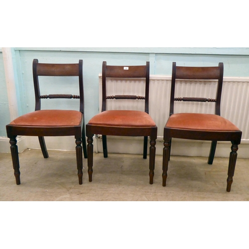 41 - A set of six William IV mahogany framed dining chairs, each with a rope carved splat and upholstered... 