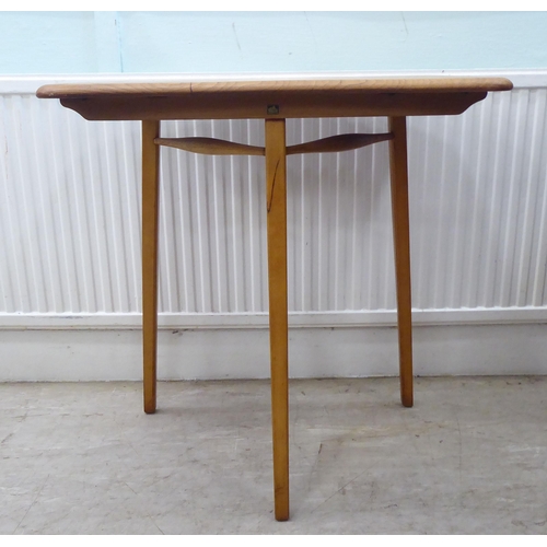 51 - Vintage Ercol beech and elm furniture, comprising four low hoop and spindled back dining chairs; a s... 