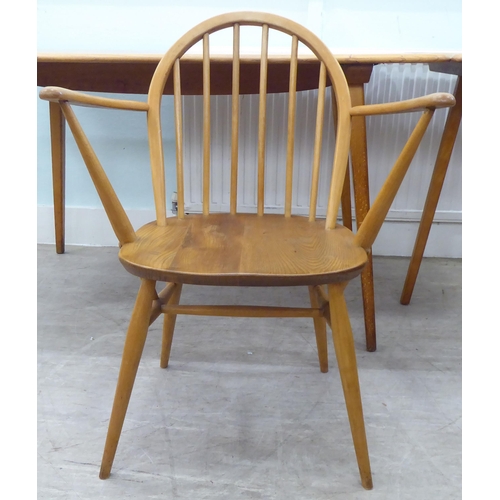 51 - Vintage Ercol beech and elm furniture, comprising four low hoop and spindled back dining chairs; a s... 