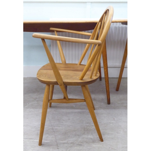 51 - Vintage Ercol beech and elm furniture, comprising four low hoop and spindled back dining chairs; a s... 