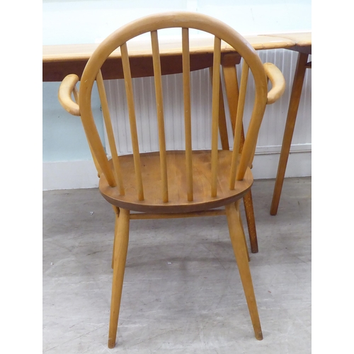 51 - Vintage Ercol beech and elm furniture, comprising four low hoop and spindled back dining chairs; a s... 