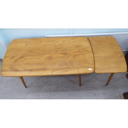 51 - Vintage Ercol beech and elm furniture, comprising four low hoop and spindled back dining chairs; a s... 