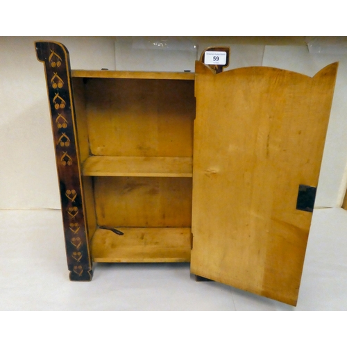 59 - An early 20thC Art Nouveau pokerworked satinwood cabinet with a single door, raised on bracket feet ... 