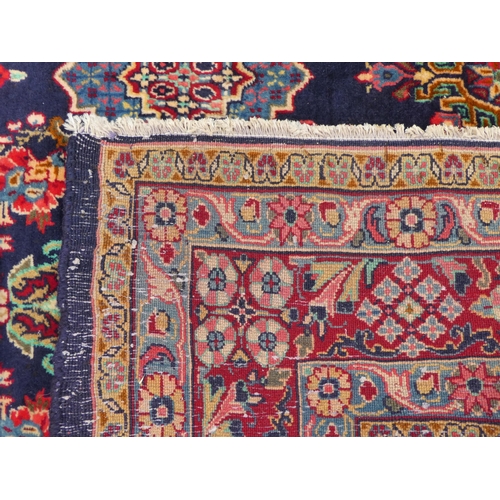 84 - An Iranian rug, decorated with repeating floral ornament, on a multi-coloured ground  53