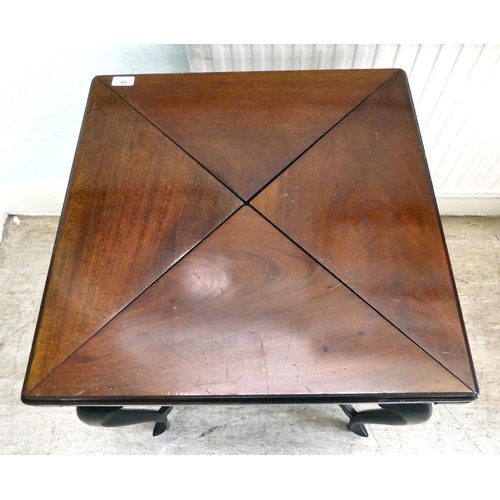 88 - A 1930s mahogany envelope style card table with a rotating top, enclosing a baize lined interior, ov... 