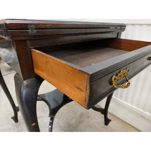 88 - A 1930s mahogany envelope style card table with a rotating top, enclosing a baize lined interior, ov... 