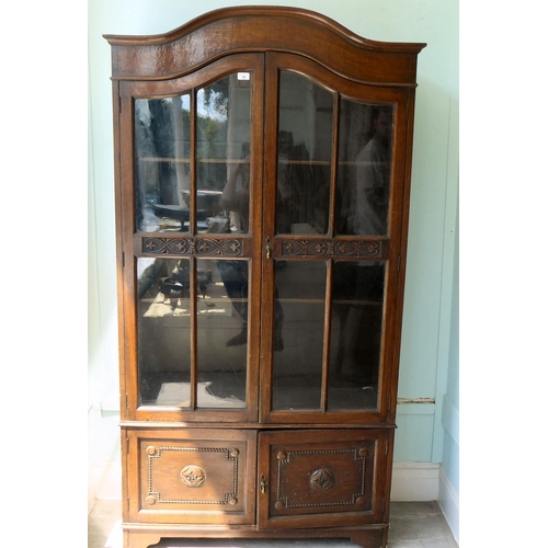 91 - An early 20thC oak round arched, cabinet bookcase, the pair of three-quarter height, glazed panelled... 