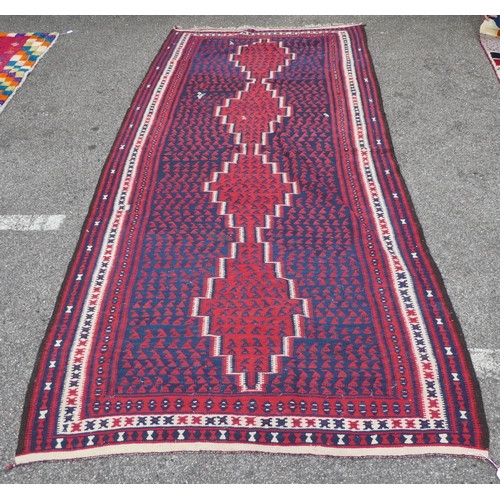 99 - A Balouch style rug/runner, on a mainly red ground  57