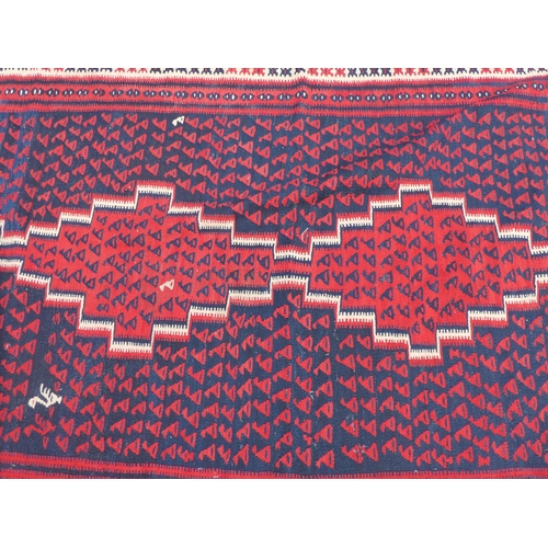 99 - A Balouch style rug/runner, on a mainly red ground  57