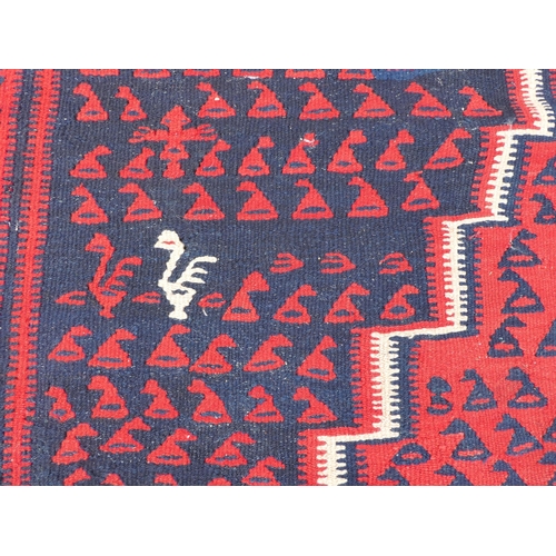 99 - A Balouch style rug/runner, on a mainly red ground  57