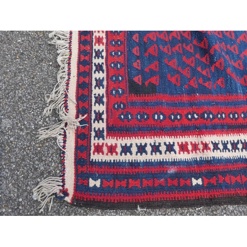 99 - A Balouch style rug/runner, on a mainly red ground  57