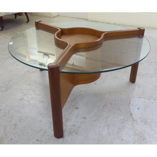 109 - A 1960s laminated teak coffee table of star design with three inset, clear glass panels, around a ce... 