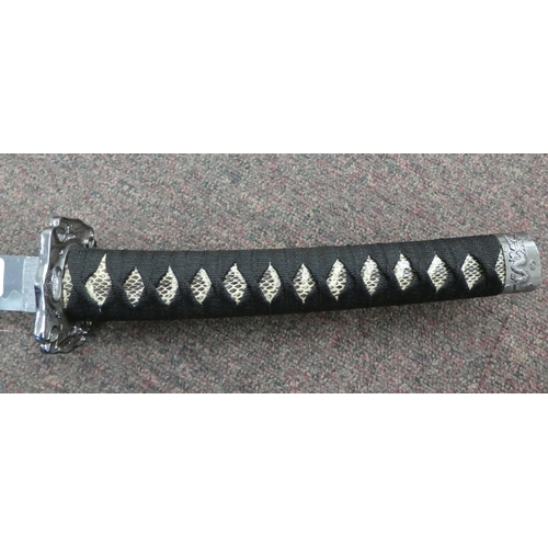 11 - An early/mid 20thC (possibly North African) machete, the blade 25