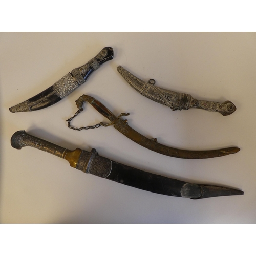 111 - Four various mid 19thC Asian edged weapons: to include a dagger with a curved blade  11