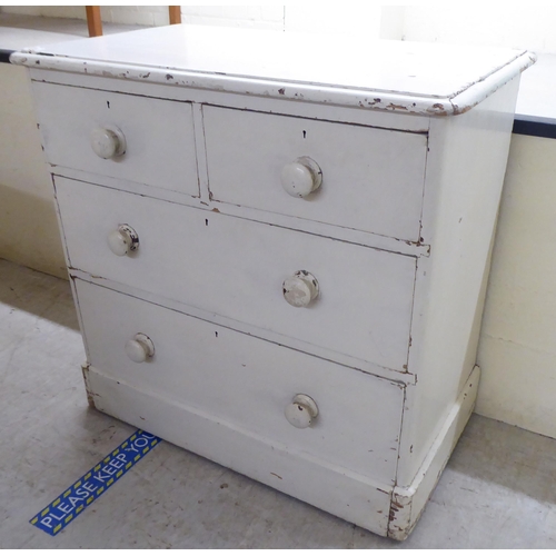 12 - A late Victorian off-white, overpainted, pine four drawer dressing chest, on a plinth  33