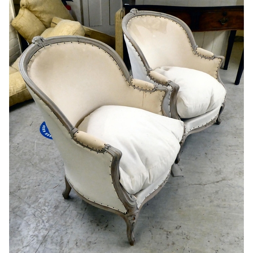 15 - A pair of modern French inspired, grey painted showwood framed, enclosed arm, salon chairs (not upho... 