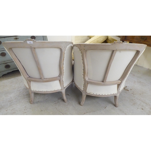 15 - A pair of modern French inspired, grey painted showwood framed, enclosed arm, salon chairs (not upho... 