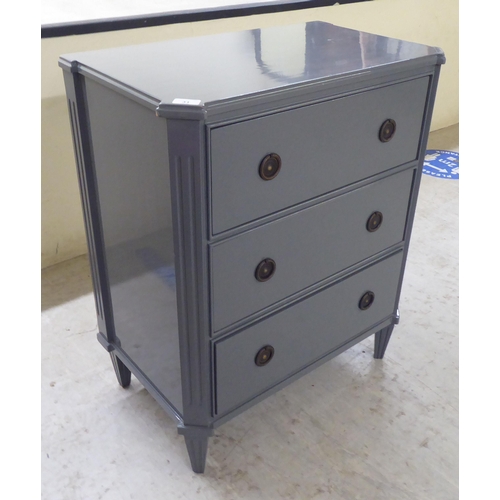 31 - A modern dark grey painted, three drawer dressing chest, raised on tapered legs  32