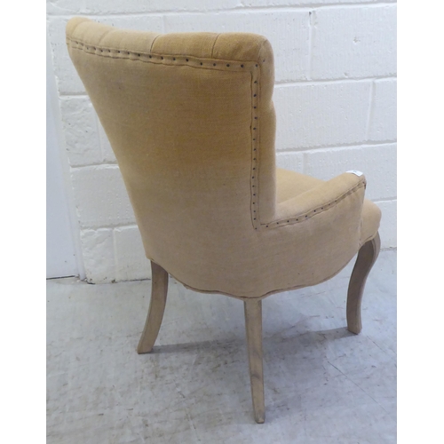 36 - A modern French inspired fabric covered bedroom chair, raised on cabriole forelegs