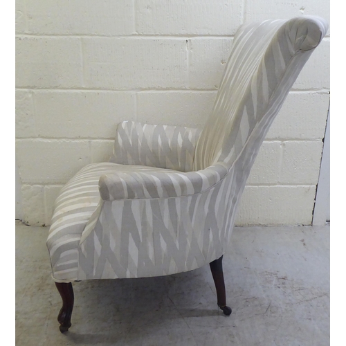 41 - A late Victorian and later fabric upholstered bedroom chair, raised on cabriole forelegs and casters